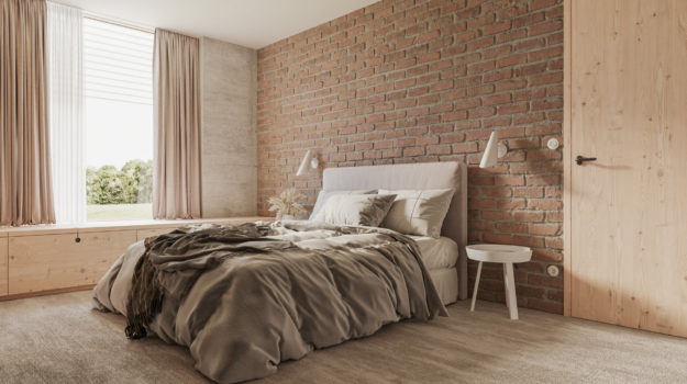 Návrh spálne v škandinávskom dizajne. Tehlová stena v kombinácii so svetlosivým kobercom a masívnym drevom.